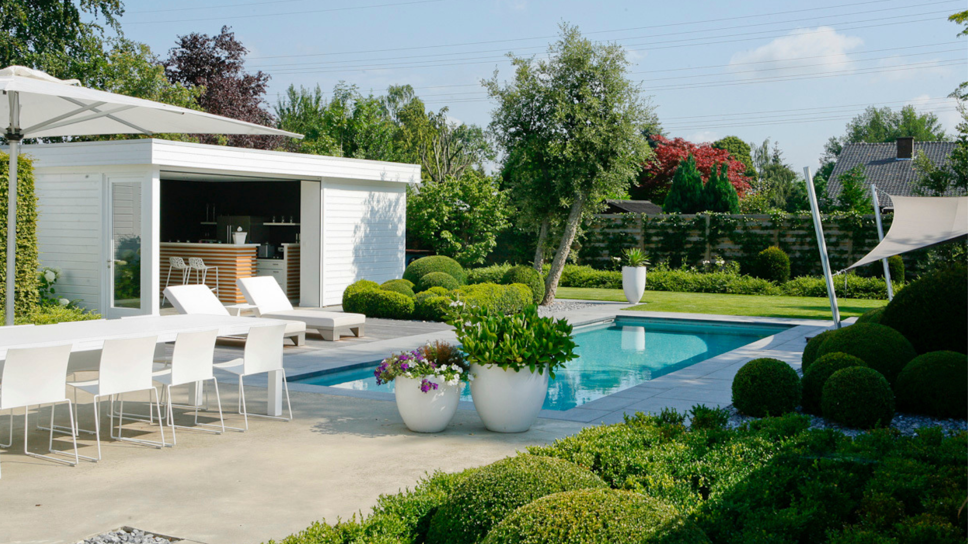 Moderne tuin met zwembad, poolhouse en tuinmeubels